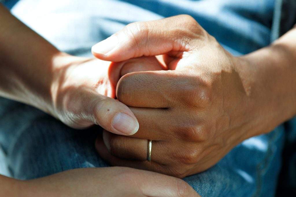 care worker holding hands with patient