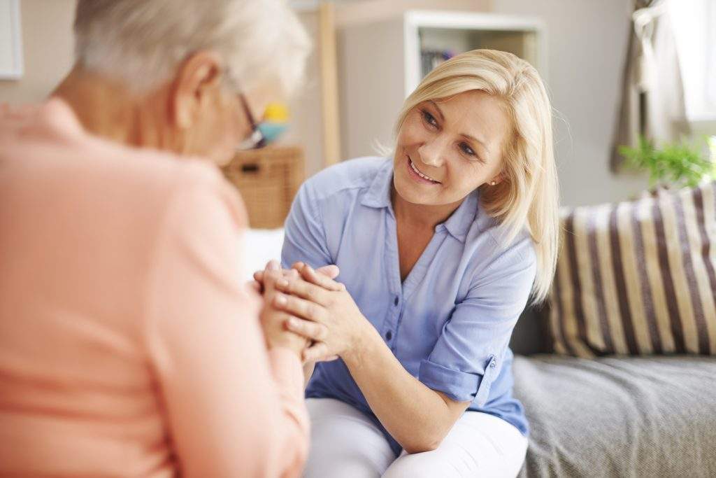 care assistant helping care home resident