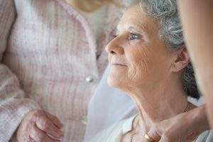 elderly woman being cared for - care certificate standards